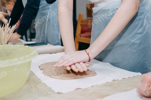 Preview: Female hands kneading clay. Production of ceramic products at the master class on ceramics