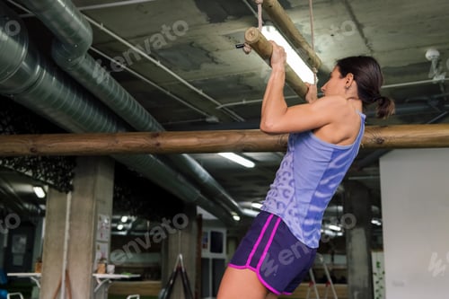 Preview: sportswoman trains her strength by doing pull-ups