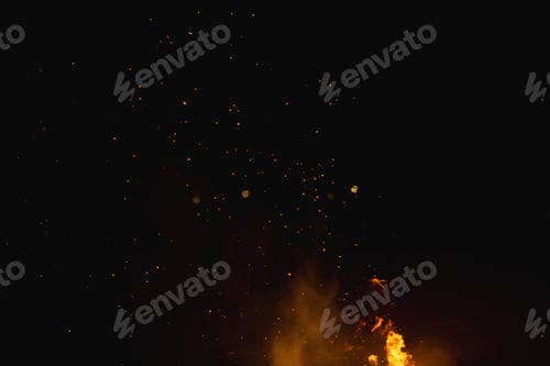 Preview: Low angle shot of fire flames with the background of the dark sky during night time
