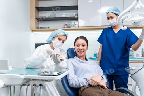 Preview: Caucasian dentist examine tooth for young girl at dental health clinic.
