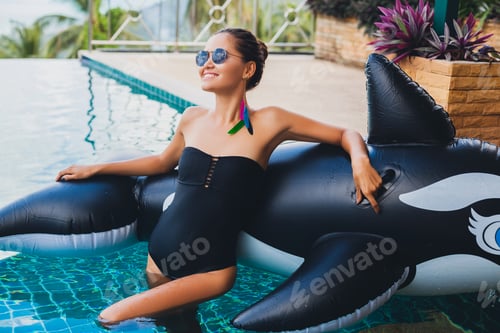 Preview: beautiful asian woman having fun in pool on tropical villa