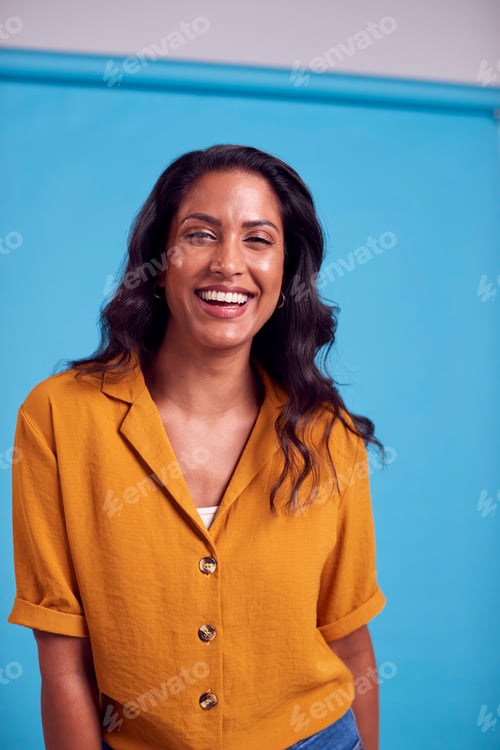Preview: Portrait Of Mature Female Model Posing For Photographer Against Background On Studio Fashion Shoot