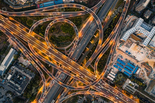 Preview: Shot of a bustling city intersection at night with cars driving on the illuminated roads