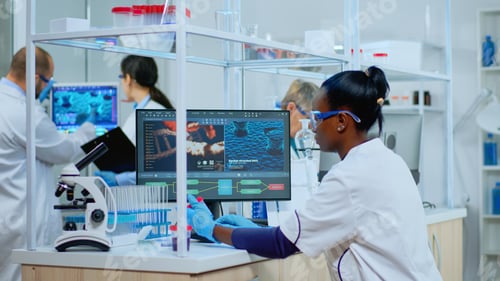 Preview: Black woman researcher carrying out scientific research in lab
