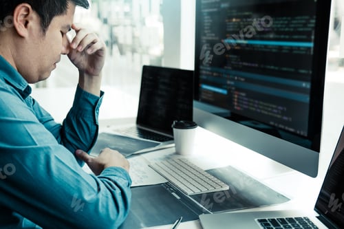 Preview: Software developers headache with code analysis in the office.