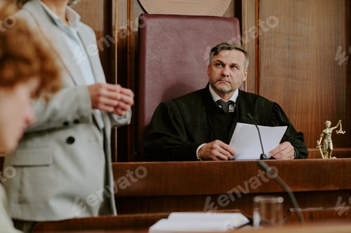 Preview: Middle Aged Caucasian Male Judge Listening to Lawyer Presenting Case in Courtroom