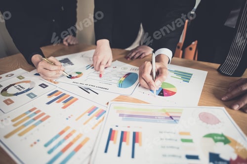 Preview: Business Team Analyzing Charts and Graphs Together