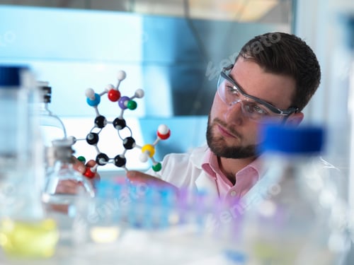 Preview: Scientist examining molecular model in laboratory