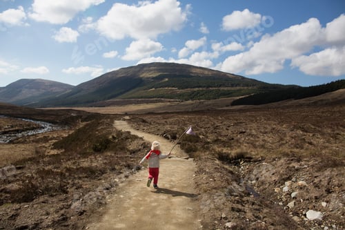Preview: Boy on path with flag, Fairy Pools, Isle of Skye, Hebrides, Scotland