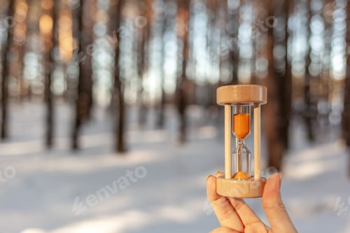 Preview: Hourglass in the snow. Spring is coming. melting snow