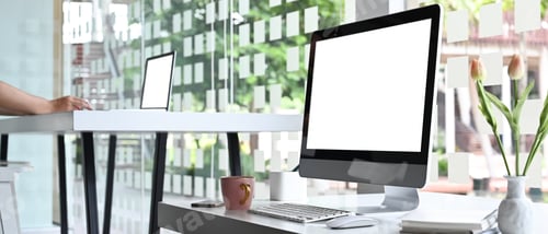 Preview: A computer monitor with a white blank screen is putting on a white working desk.