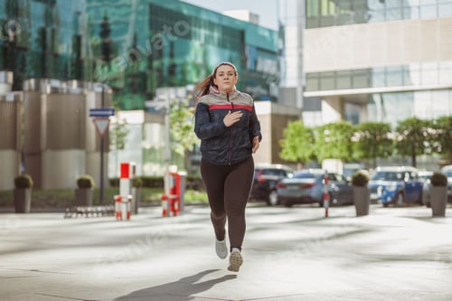 Preview: overweight positive woman running outdoor