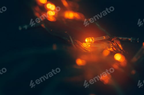 Preview: Illuminated garland close up on dark background