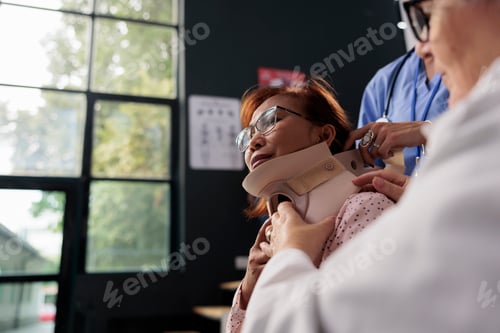 Preview: Medical assistant and doctor helping senior patient