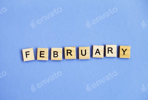 Preview: inscription February made by wooden cubes on a veri peri purple background.