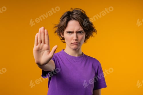 Preview: Uninterested woman disapproving with NO sign gesture. Keep your distance, enough