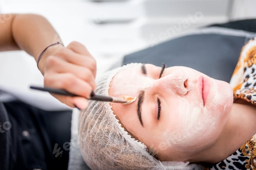 Preview: Beautician applying facial mask at beauty salon, cosmetology treatment skincare face