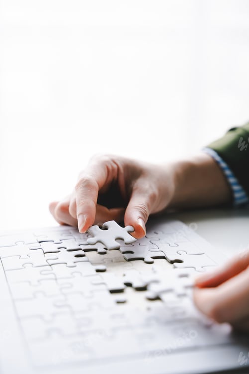 Preview: Close-up of business hands connecting with jigsaw puzzle achievements and goals Business concept, st