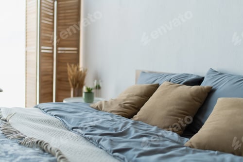 Preview: Pillows on comfortable bed in blurred bedroom