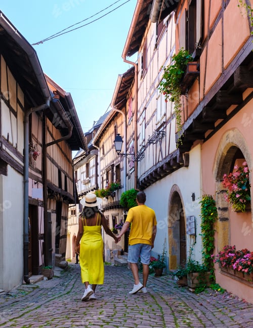 Preview: Couple walking at Beautiful view of colorful romantic city Eguisheim near Colmar, France, Alsace