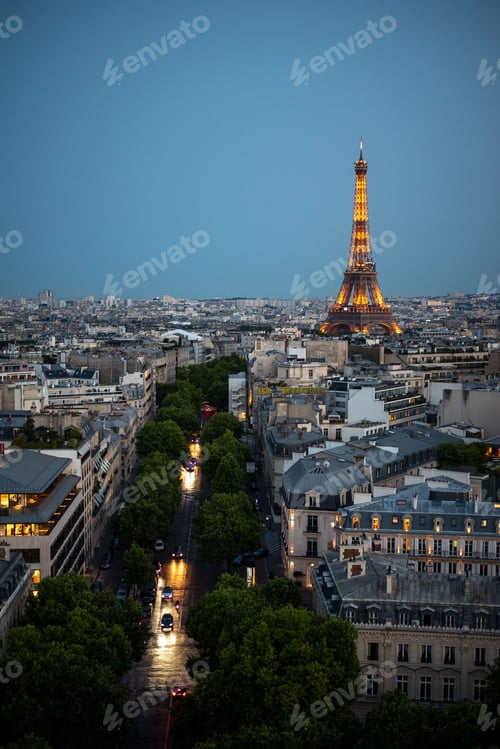 Preview: Vertical aerial view of the glowing Eiffel Tower over the skyline of Paris, France