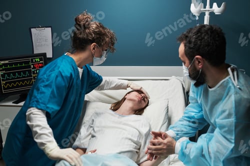 Preview: Caucasian Young Adult Woman Receiving Medical Care from Doctors in Hospital