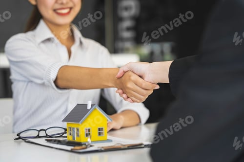Preview: Successful deal Real estate lease or home purchase concept buyer shakes hands with bank employee aft