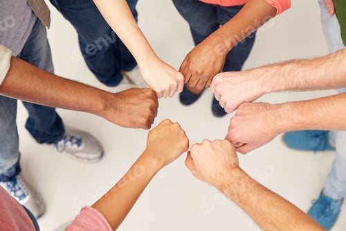 Preview: hands of international people making fist bump