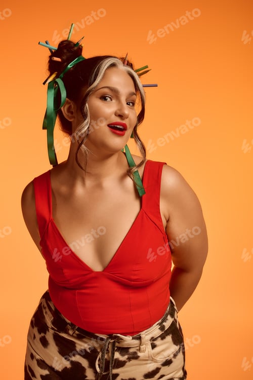 Preview: Young woman with unique style and vibrant ribbons on a bright orange background