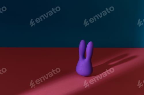 Preview: Violet dildo vibrator for clitoris on colored background with contrast shadows. Sex toy for adult