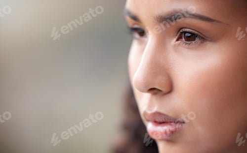 Preview: Closeup shot of a beautiful young woman looking thoughtful while standing outside