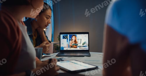 Preview: Asia businesswomen using laptop talk to colleagues about plan in video call meeting.