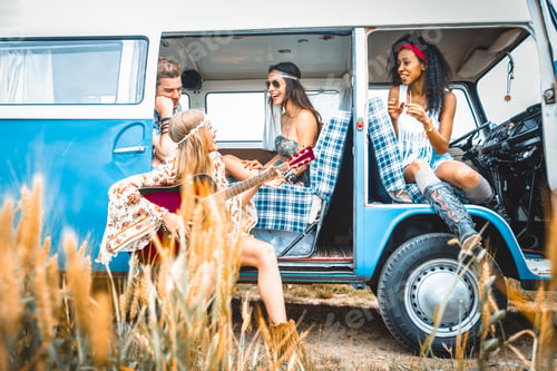 Preview: Happy friends driving a vintage minivan