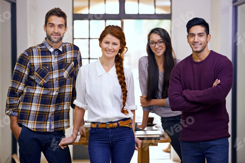 Preview: Cropped shot of four young designers standing in their office