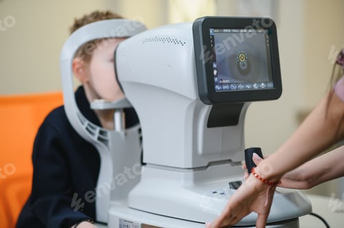 Preview: Ophthalmologist using autorefractor for eye examination of child in clinic