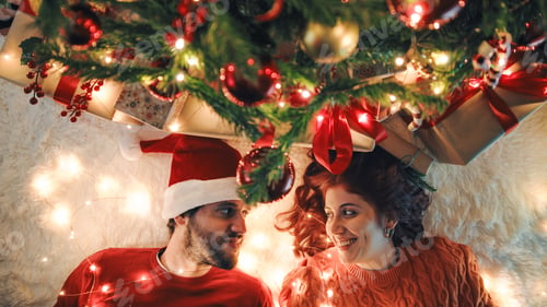 Preview: Lovely couple playing with the Christmas ball under the tree