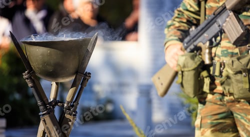 Preview: Fire in a soldier helmet and an armed soldier during a memorial ceremony