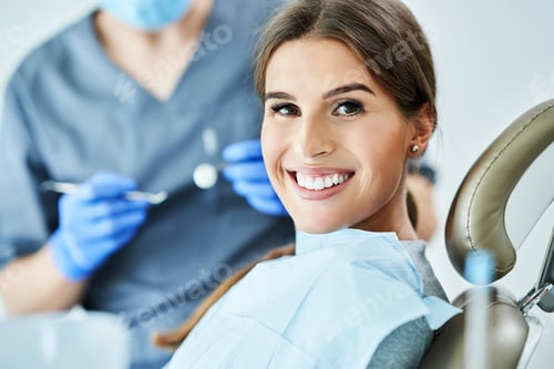 Preview: Male dentist and woman in dentist office