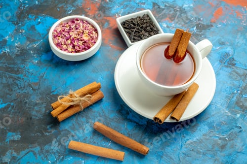 Preview: bottom view a cup of tea with cinnamon different stuffs in small bowls on blue red background