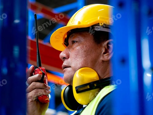 Preview: Male man foreman yellow hardhat safety helmet architect engineer talking radio telephone smartphone