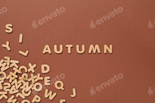 Preview: Word Autumn and letters on brown background
