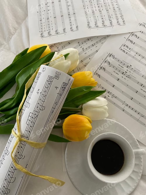 Preview: Overhead shot of music sheets with coffee and spring tulips