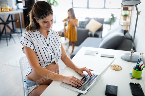Preview: Pregnant woman working from home. Career and pregnancy concept