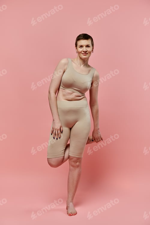 Preview: Woman in bra and shorts posing for breast cancer awareness