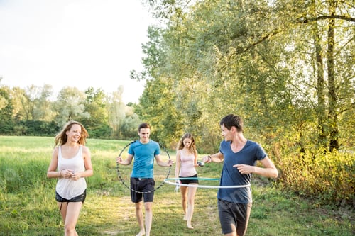 Preview: Group of friends in field, using hula hoops