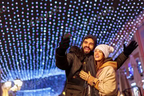 Preview: Couple taking selfies while celebrating New Year in the city streets