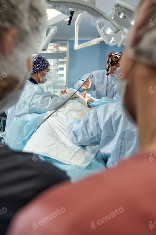 Preview: Surgeons Performing Operation in Brightly Lit Operating Room