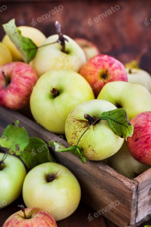 Preview: Fresh ripe colorful apples in wooden box on rustic background