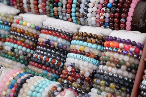 Preview: Colorful bead bracelets displayed at a market stall