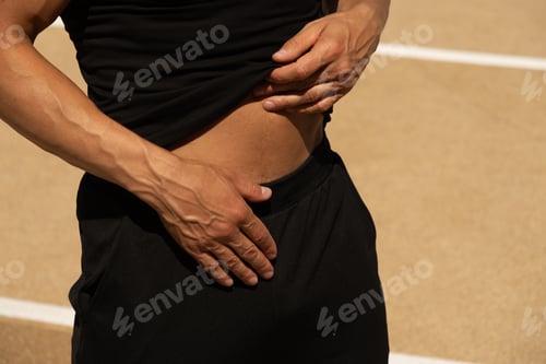 Preview: Man holds his abdomen in pain, highlighting discomfort